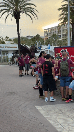 Group gathers along Salou's palm-lined promenade on a summer evening
