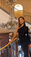 Woman poses for photos on ornate Moscow staircase