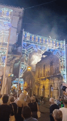 Night festival lights up a crowded decorated street