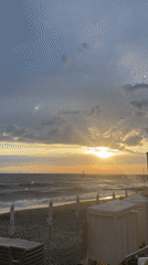 Breakdancer performs at Sochi beach during dramatic sunset
