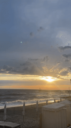 Breakdancer performs at Sochi beach during dramatic sunset