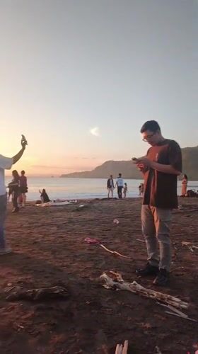 Sunset beach gathering draws photographers in Ciwaru, Indonesia