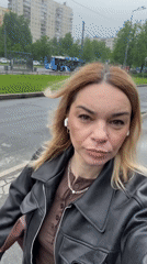 Woman films herself walking on wet street in Vsevolozhsk