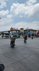 Morning traffic flows through Chiang Mai intersection with police presence