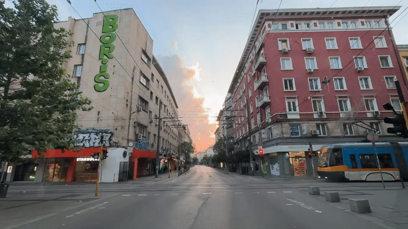 Sofia street scene with sunset clouds and a 'Boris' building