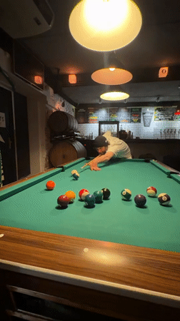 Pool player makes successful shot in Barcelona bar