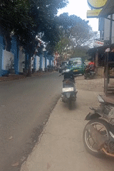 Morning street scenes in Bandung amid flags and motorcycle activity