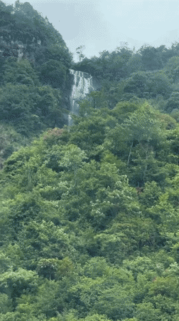 Vehicle captures mountain scenery with waterfall in Sa Pa