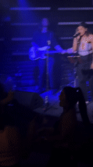 Female singer performs with band on London stage