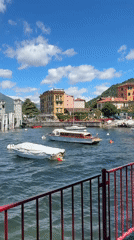 Tourists capture scenic Varenna waterfront views during morning visit