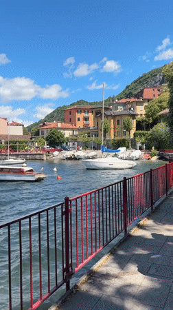 Tourists capture scenic Varenna waterfront views during morning visit