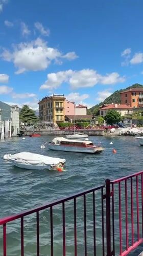 Tourists capture scenic Varenna waterfront views during morning visit