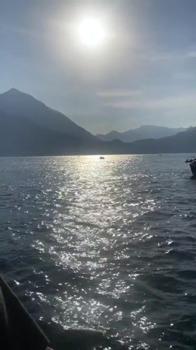Ferry carries red Mustang across Lake Como at Varenna