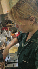 Woman cooks liver and onions in Chaikovsky kitchen
