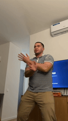 Man dances in living room in Tbilisi