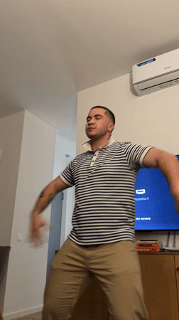 Man dances in living room in Tbilisi