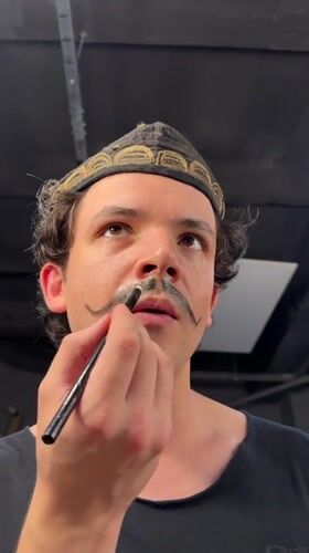 Man receives mustache makeup application in Tashkent