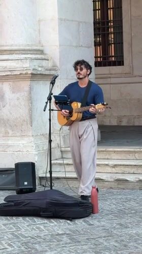 Street musician performs near Basilica di Santa Maria Maggiore, Bergamo