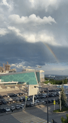 Rainbow appears over Ufa Congress Hall during stormy weather