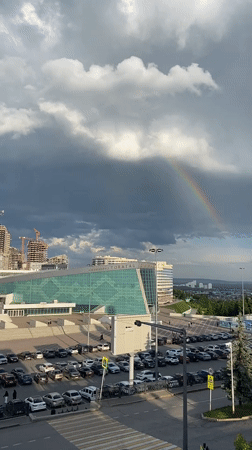 Rainbow appears over Ufa Congress Hall during stormy weather