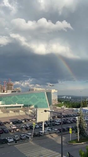 Rainbow appears over Ufa Congress Hall during stormy weather