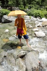 Morning scenes of monk crossing streams and children playing in rural India
