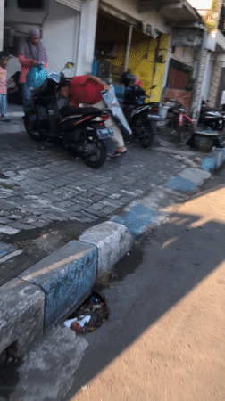 Everyday street traffic flows through Sidoarjo's commercial district