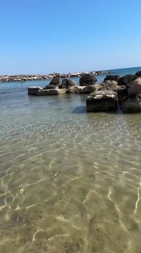 Lazy afternoon at Coral Bay's rocky Mediterranean shore
