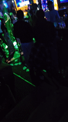 Nightclub scene shows scattered money on floor amid crowds