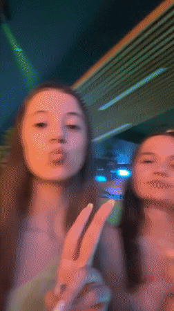 Young women dining, making gestures at Gotse Delchev restaurant