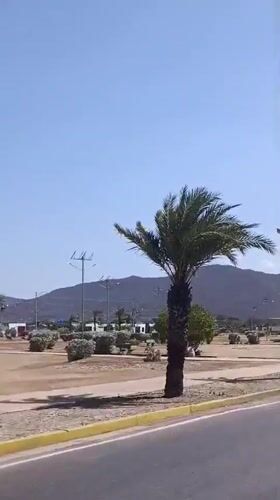 Vehicle drives through Juan Griego on clear afternoon