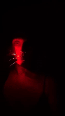 Woman uses blue light therapy device in Fethiye