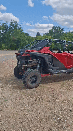 Red and black UTV parked on gravel in Hîncești, Moldova