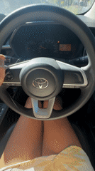 Driver with red nails steers Toyota through Kuta Selatan