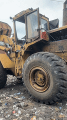 CAT loader moves household waste into trucks in Badagry