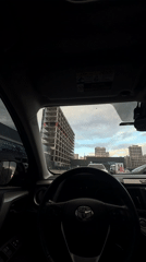Driver photographs modern building from car in Kyiv