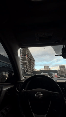 Driver photographs modern building from car in Kyiv