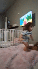 Toddler plays with giant plush duck toys in Russian home