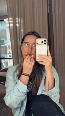 Woman Takes Selfie While Eating Sandwich in Moscow