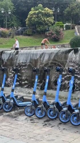 Blue scooters parked near a water feature in Tbilisi