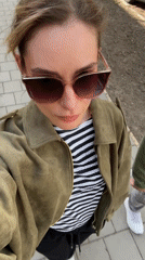 Woman in striped shirt walks Kiel streets