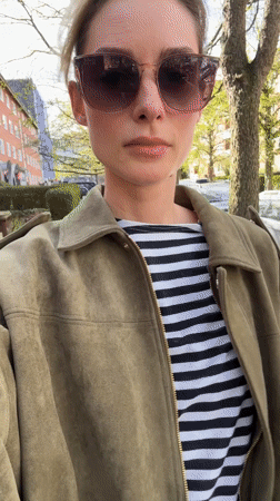 Woman in striped shirt walks Kiel streets