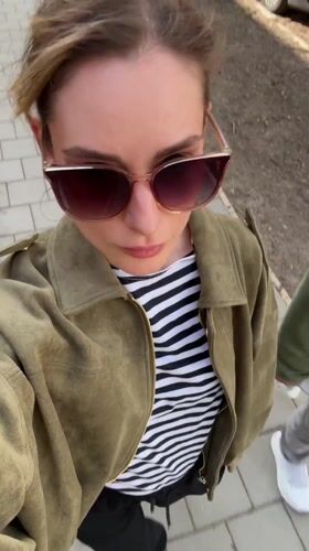 Woman in striped shirt walks Kiel streets