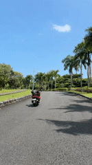 Morning scooter riders and empty roads captured in Bali