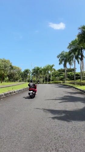 Morning scooter riders and empty roads captured in Bali