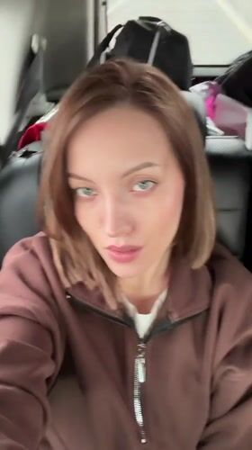 Woman records selfie video from car passenger seat in Klin