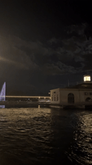 Quiet Geneva waterfront at night, lights reflecting on dark water