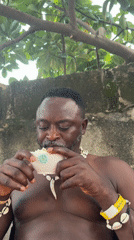 Man in shell jewelry enjoys popcorn across Nigerian locations
