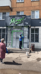 Morning storefront cleaning at Novokuznetsk coffee shop