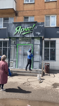 Morning storefront cleaning at Novokuznetsk coffee shop
